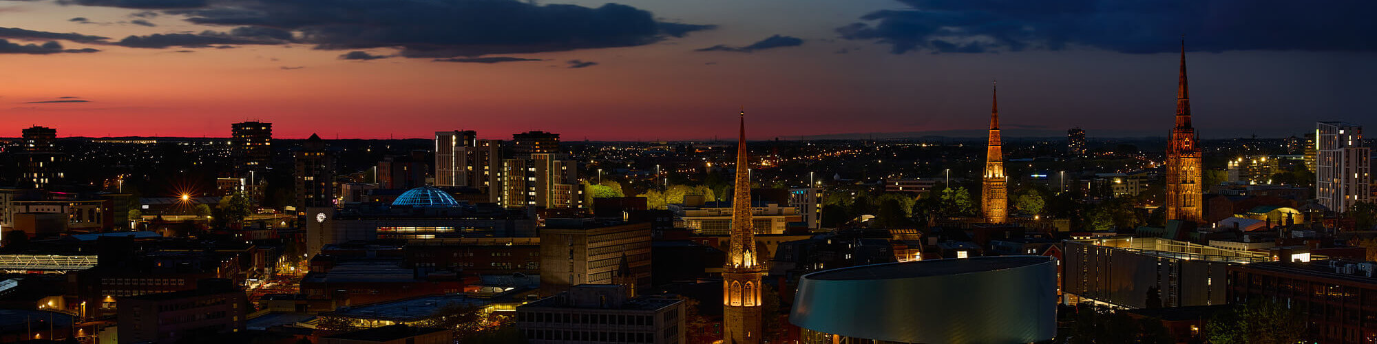 Coventry's three spires and sunset banner